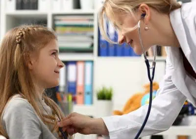 Stock image of a Pediatrician Examining a Small Child With Stethoscope.