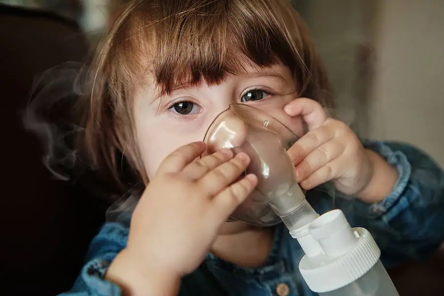 Girl with a severe allergy receives a nebulizer