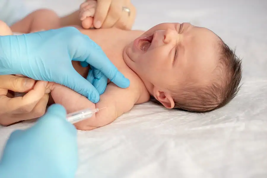 Newborn baby being immunised