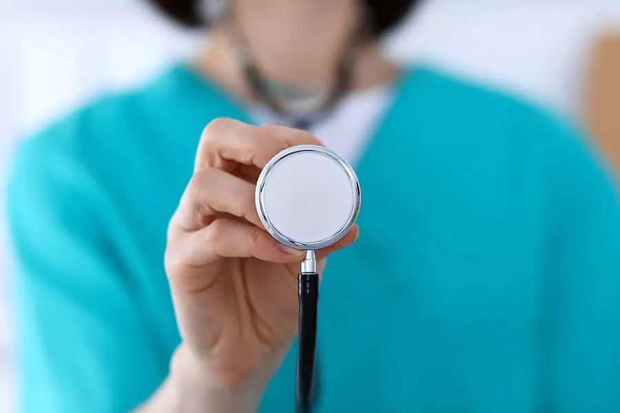 Physician about to listen to the heart of a patient