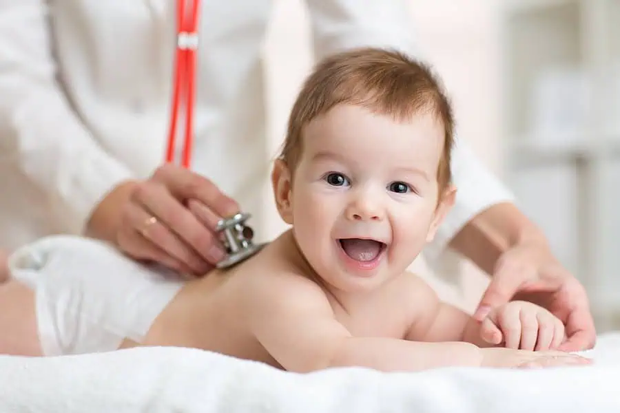 A doctor is examining a young baby as part of a comprehensive paediatric service.