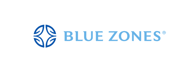 Blue Zones logo featuring a circular design with four leaf-like shapes on the left and the text "BLUE ZONES" in capital letters on the right.